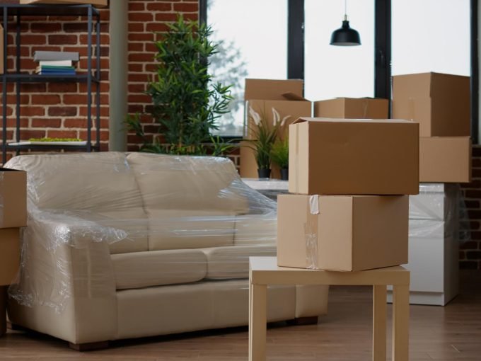 no-people-living-room-interior-move-with-carton-boxes-empty-real-estate-property-full-cardboard-packing-storage-cargo-nobody-apartment-relocation-moving-day
